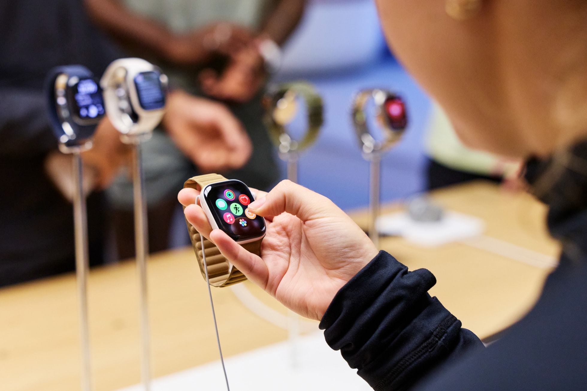 A customer holds and explores an Apple Watch Series 12 at Apple Covent Garden in London.