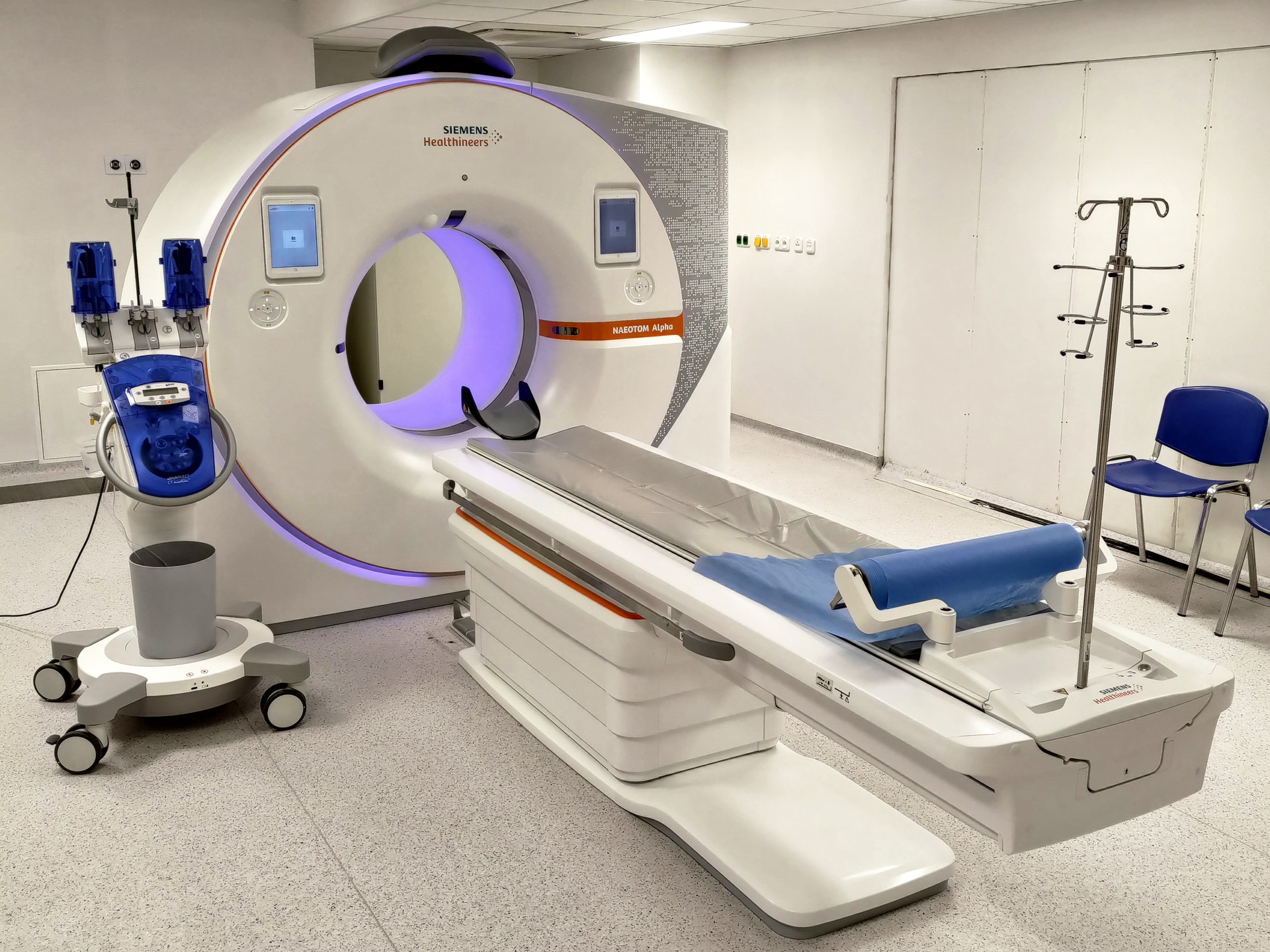Siemens NAEOTOM Alpha CT scanner with its patient table in an imaging room.